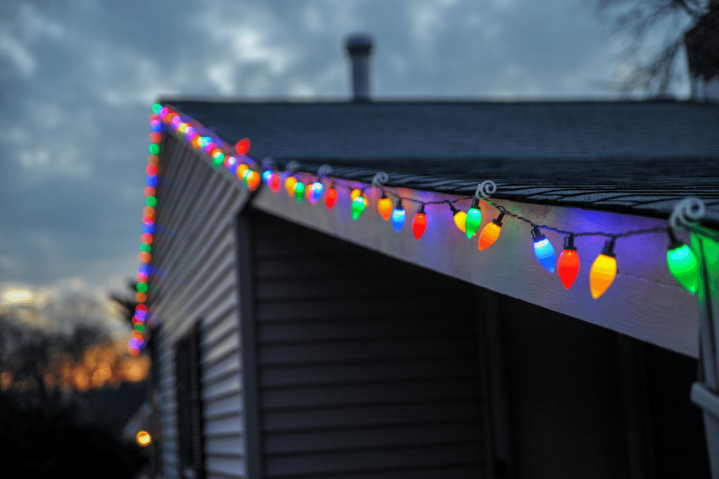 Colorful holiday lights lining a house roof.