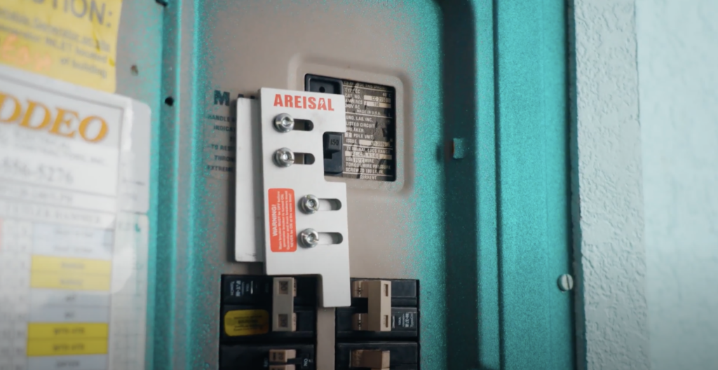 A close up of an interlock switch installed in a circuit panel