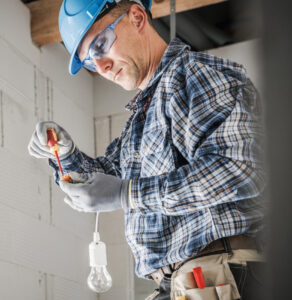 an electrician preparing a light point inside a newly built room