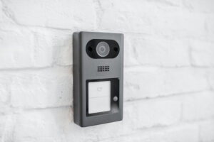 House intercom with a camera on an outdoor brick wall