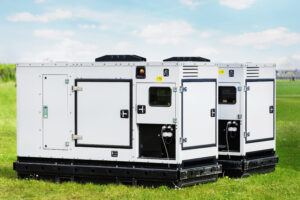 Set two large industrial power fuel generator on a green lawn.