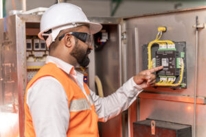 Team of engineers taking care of machines in the factory so that they can be used continuously.