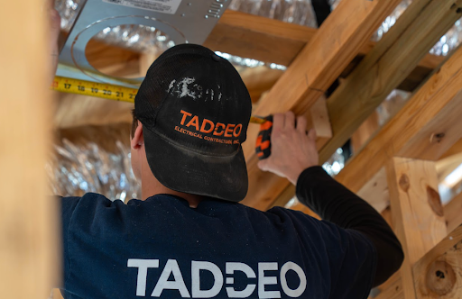 Taddeo Electric technician installing energy efficient electrical upgrades in a West Central Florida home attic